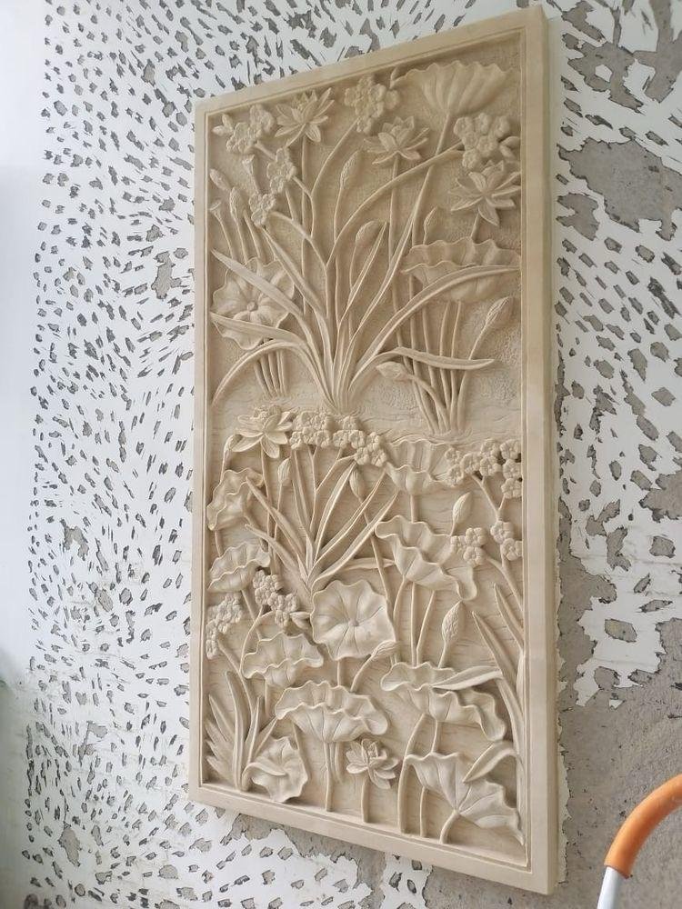 Sandstone wall panel with floral botanical carving installed on interior feature wall